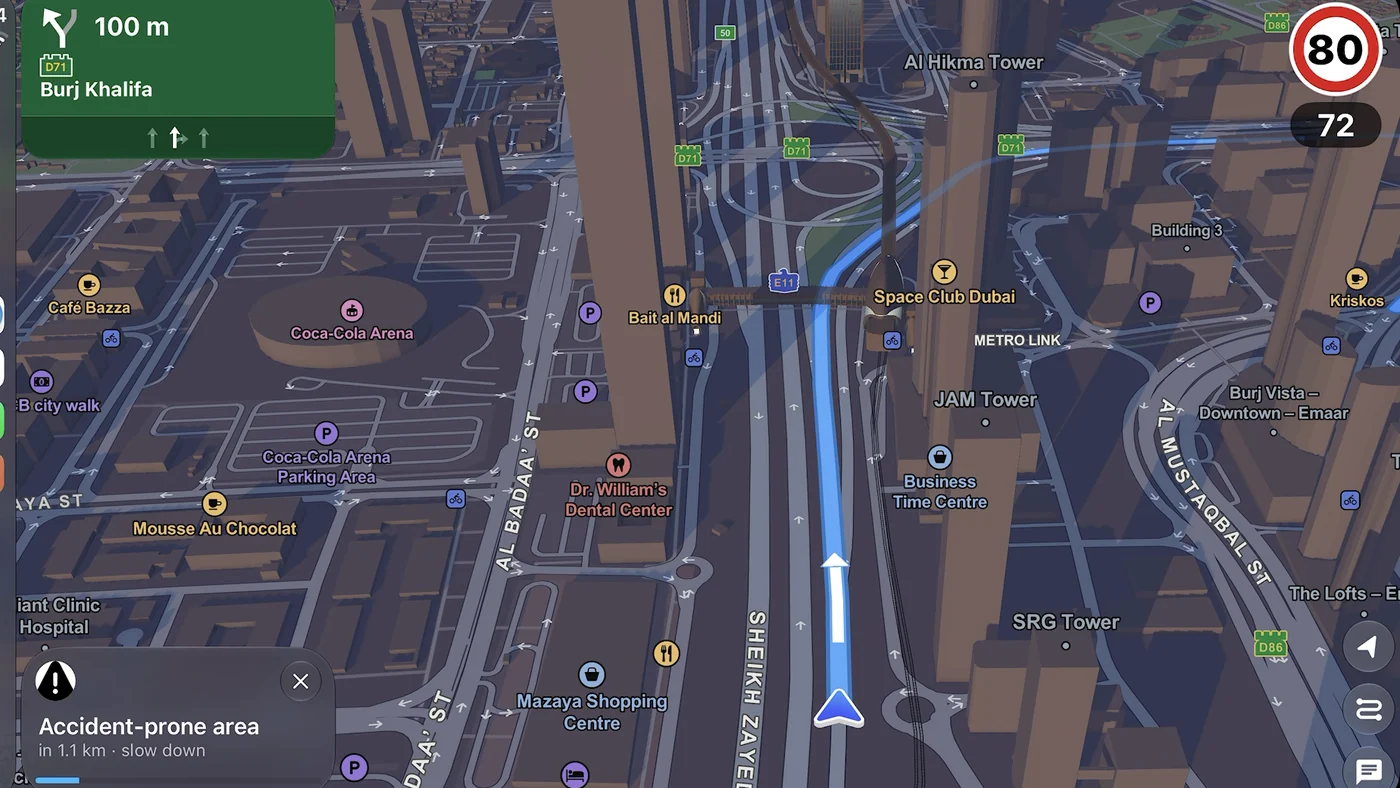 Guardian AI on CarPlay in 3D Downtown Dubai: green sign for Burj Khalifa and a card, accident-prone area in 1.1 km, slow down